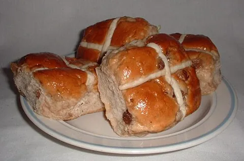 hot cross bun: a bun, made with yeast and containing spices, currants and candied fruit, with a cross marked on...