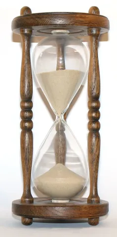 hourglass: a clock made of two glass vessels connected by a narrow passage through which sand flows