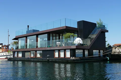 houseboat: a vessel, such as a barge, used as a dwelling