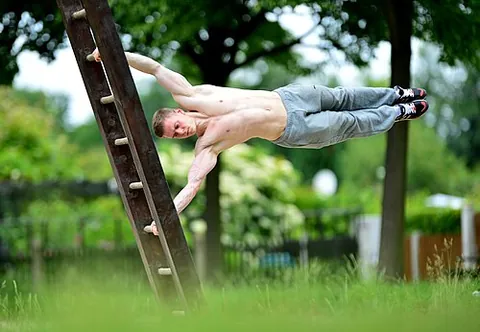 human flag: a feat of strength where the body is parallel to the ground supported by a vertical bar