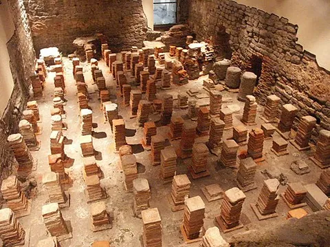 hypocaust: an underfloor space or flue through which heat from a furnace passes to heat the floor of a room or...