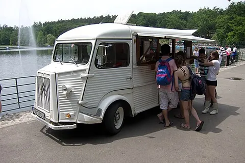 ice cream truck: a vehicle from which ice cream is sold at the roadside, mostly to children