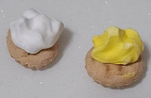 iced gem: a small, crunchy biscuit topped with a swirl of hard, often brightly coloured icing