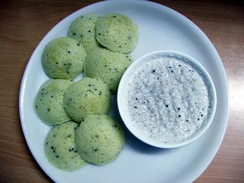 idli: a South Asian cake made from a mixture of ground rice and lentils fermented and steamed in a mold