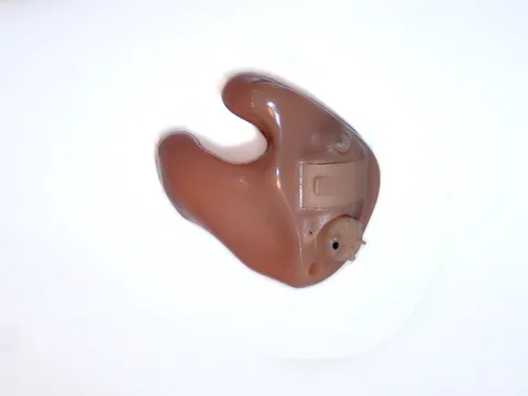 in the ear: describing a type of hearing aid that fits within the concha of the wearer's ear