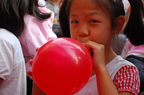 inflate: to enlarge an object by pushing air (or a gas) into it; to raise or expand abnormally