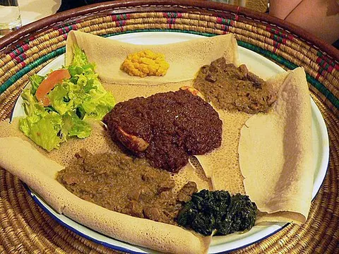 injera: a pancakelike flatbread made from fermented teff flour, a traditional food of Eritrea, Ethiopia,...