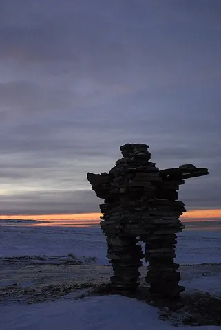 inukshuk: a structure of piled stones, used as a landmark and traditionally constructed by the Inuit, often...