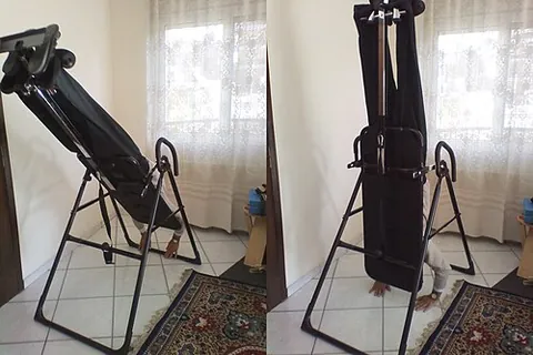 inversion table: a device to enable a person to be comfortably upside-down as part of inversion therapy