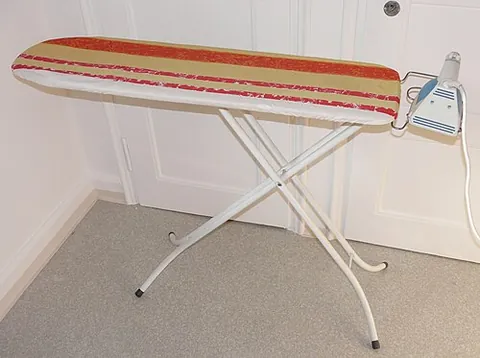 ironing board: a long board, often covered with fabric and having legs that are usually collapsible, on which one...