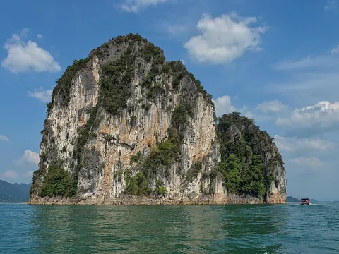 island: a contiguous area of land, smaller than a continent, totally surrounded by water