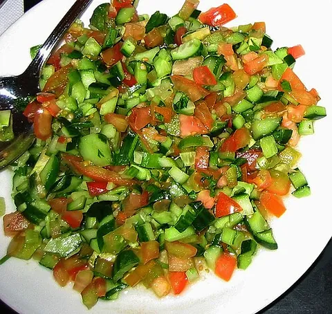 israeli salad: a salad of finely diced tomato, onion, cucumber, and bell peppers or chili peppers