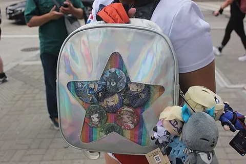 ita-bag: a handbag, backpack, or other bag decorated with fandom-related merchandise such as pins, badges,...