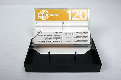 j-card: a printed card designed to fit in an audio cassette case, folded around the cassette, and usually...