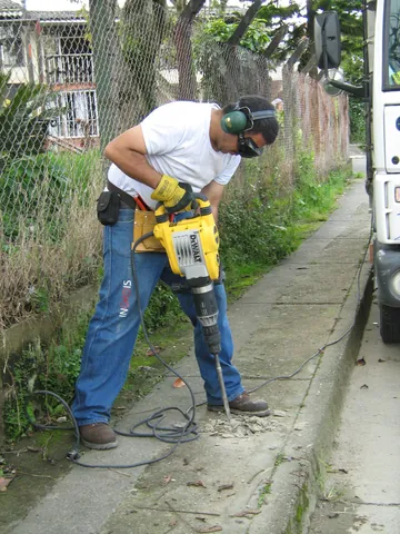 jackhammer: a portable percussive power tool that combines a hammer and chisel used to drill or break hard...