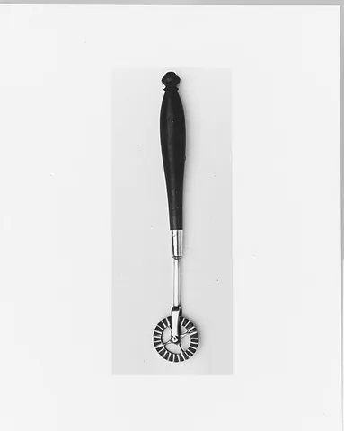 jagging iron: a kitchen implement with a zigzag or sculpted edge for cutting or crimping pie or pastry dough into...
