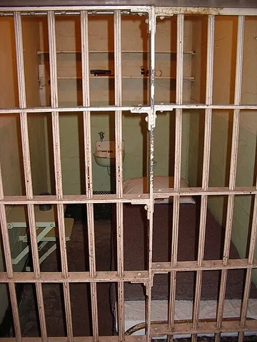jail cell: a locked room to incarcerate an inmate in prison