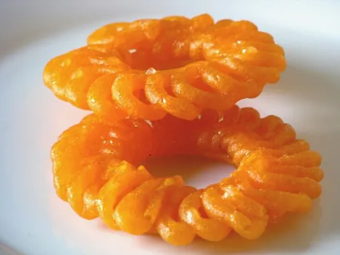 jalebi: a sweet popular in the Indian subcontinent, made by deep-frying a maida flour batter and soaking it...