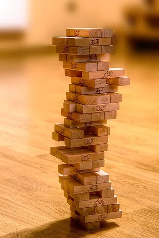 jenga: a game where players take turns removing wooden blocks from a stack formed brickwise, the loser...