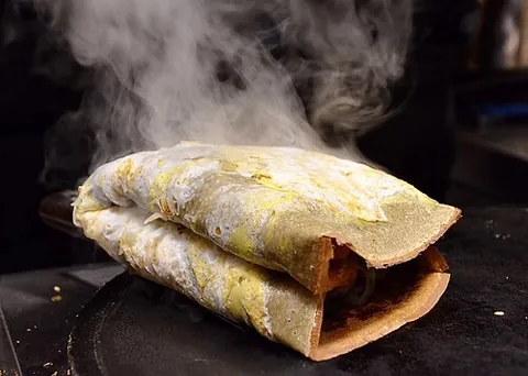 jianbing: a thin Chinese fried-egg pancake similar to a crepe, typically sold as street food