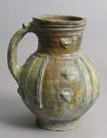 jug: a serving vessel or container, typically circular in cross-section and typically higher than it is...