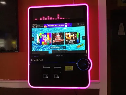 jukebox: a coin-operated machine that plays recorded music, with push-buttons to make selections