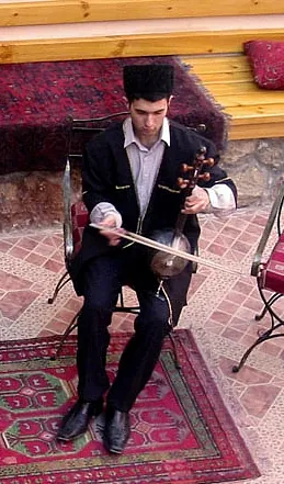 kamancheh: a long-necked stringed instrument (a spike fiddle) with a bowl-shaped body, traditionally featuring...