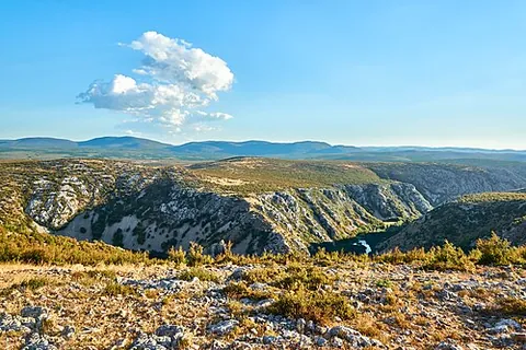 karst: a type of land formation, usually with many caves formed through the dissolving of limestone by...