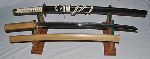 katana: a type of Japanese longsword, having a single edge and slight curvature, historically used by...