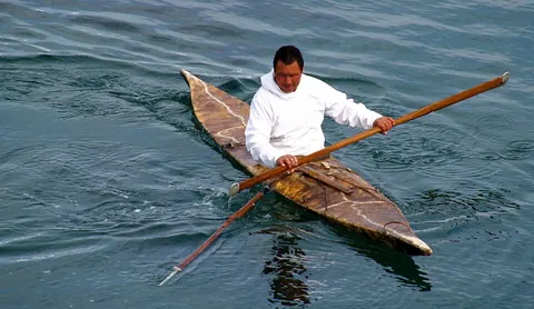 kayak: a type of small boat, covered over by a surface deck, powered by the occupant or occupants using a...