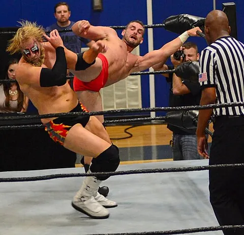 kayfabe: the act, situation, or code of portraying staged events, performances, rivalries, etc as authentic...