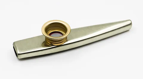 kazoo: a simple musical instrument (a membranophone) consisting of a pipe with a hole in it, producing a...
