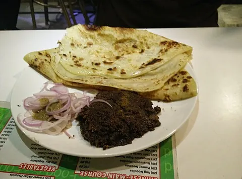 kebab paratha: a famous street food combination from Lucknow, consisting of soft kebabs served wrapped alongside a...
