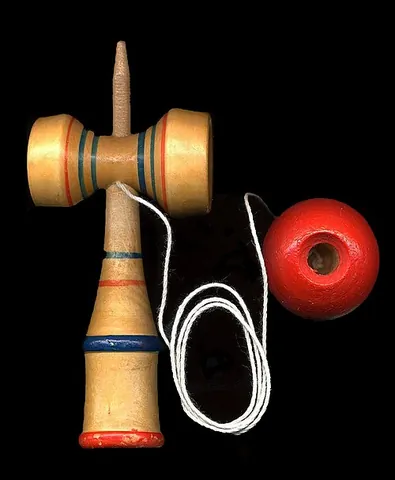 kendama: a traditional Japanese toy with an attached ball that can be caught in any of three cups or on a...