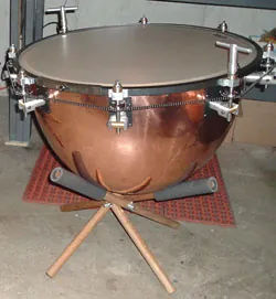 kettledrum: a large percussion instrument with a drumhead that is stretched over a hemispherical metal bowl