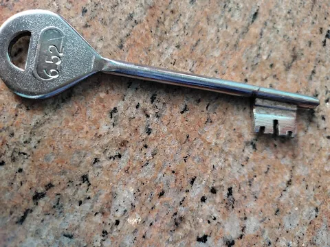 key: an object designed to open and close a lock or to activate or deactivate something, especially a...
