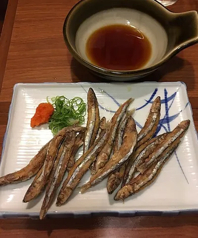 kibinago: the silver-stripe round herring or blue sprat, a small marine fish sometimes eaten for food,...