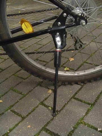 kickstand: a levered bar that can be folded down from the frame of a bicycle or motorcycle to prop it upright...