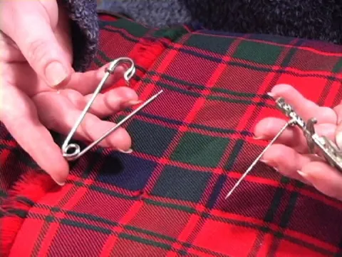 kilt pin: a pin, somewhat similar in shape, though larger than, a safety pin or bobby pin, which is inserted...