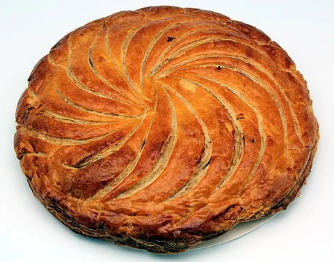 king cake: a decorative cake distributed among friends or visitors on Epiphany. In many traditions it contains...
