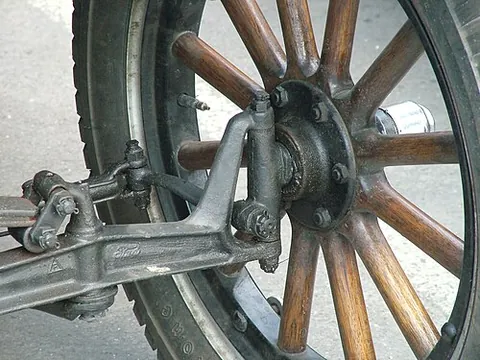 kingpin: the axis around which steered wheels pivot; a bolt that holds the axis in place