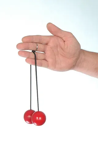 klackers: a fad toy of the 1970s, consisting of two hard balls connected by a single string