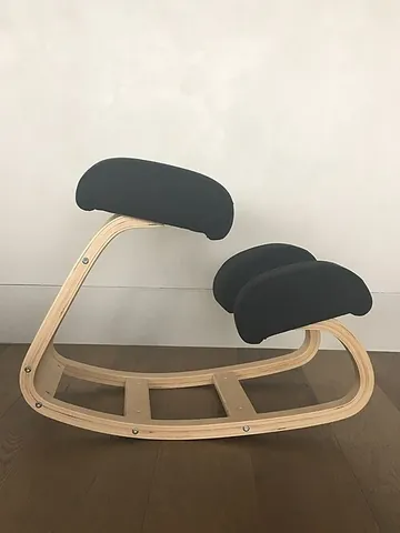 kneeling chair: a type of chair for sitting in a position with the thighs dropped to an angle of about 60 to 70...