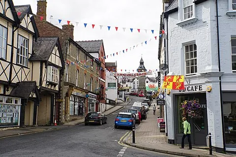 knighton: a town and community in Powys, Wales, on the border with England; its railway station is across the...