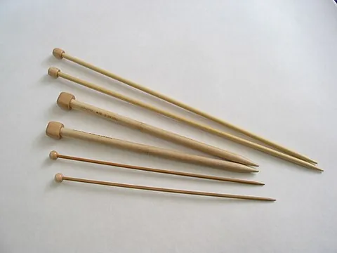 knitting needle: a long, thin, pointed rod, used in pairs to knit yarn