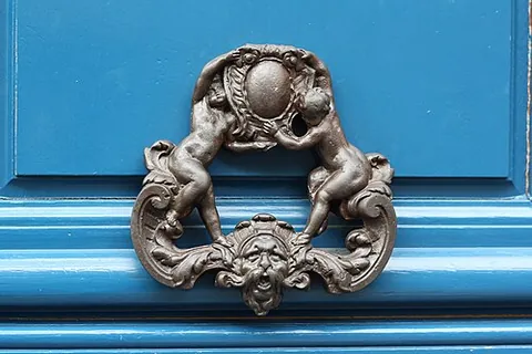 knocker: a device, usually hinged with a striking plate, used for knocking on a door