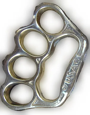 knuckle duster: a weapon made of metal worn around the knuckles that strengthens the impact of a punch