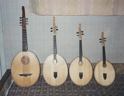 kobza: a lute-like stringed instrument traditionally made from a single block of wood, with a...