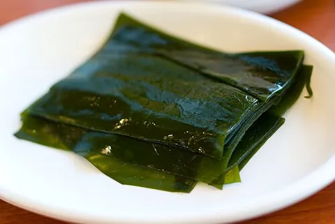 kombu: edible kelp (“a type of brown seaweed”) (from the class Phaeophyceae) used in East Asian cuisine