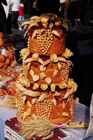 korovai: a large, single-piece round or rectangular loaf of bread, elaborately decorated and served at a...